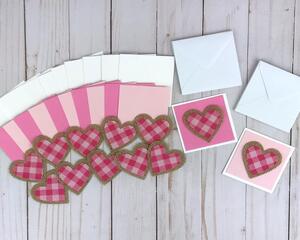 A valentine card making kit to make 12 mini valentines with cardstock, fabric and burlap heart embellishments, and cards and envelopes.